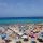 People on the beach under parasols